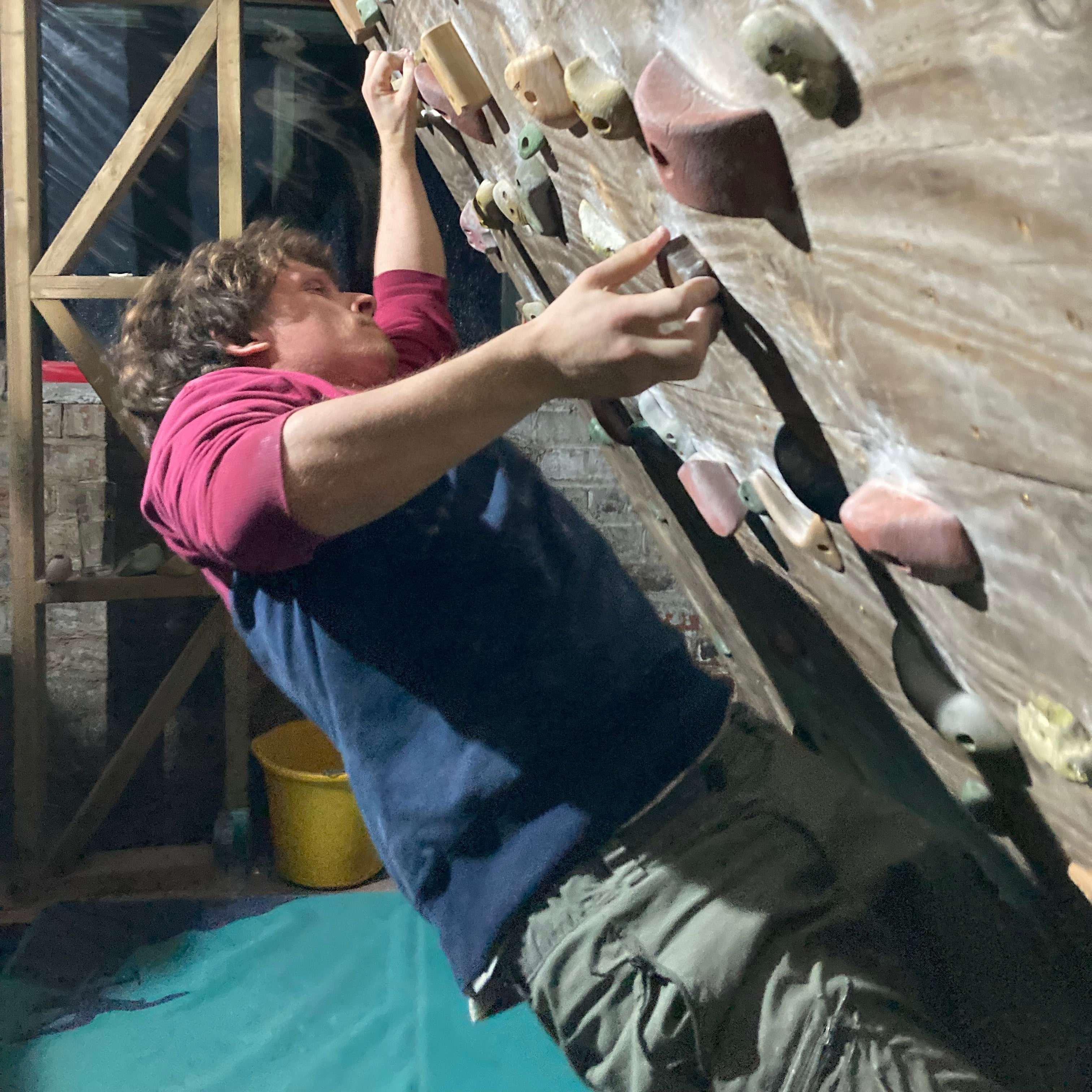 Person climbing on a rock wall indoors