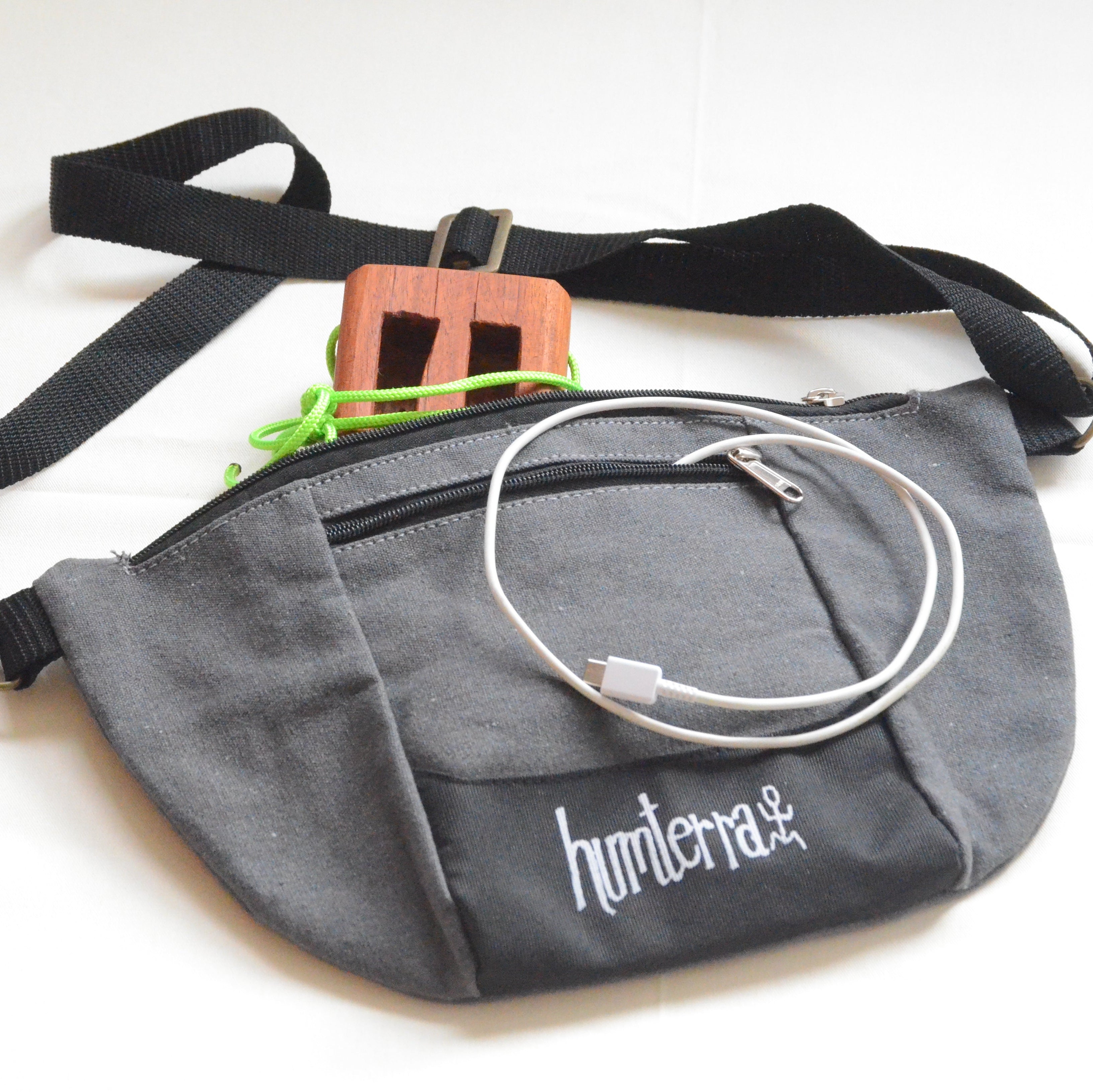 Gray waist bag with a strap and cable on a white background
