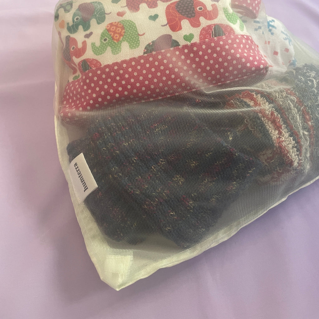 Socks in a drawstring bag on a light purple surface