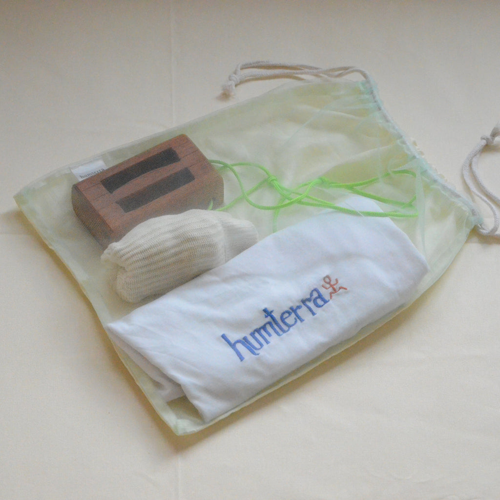 light green net bag with contents at display