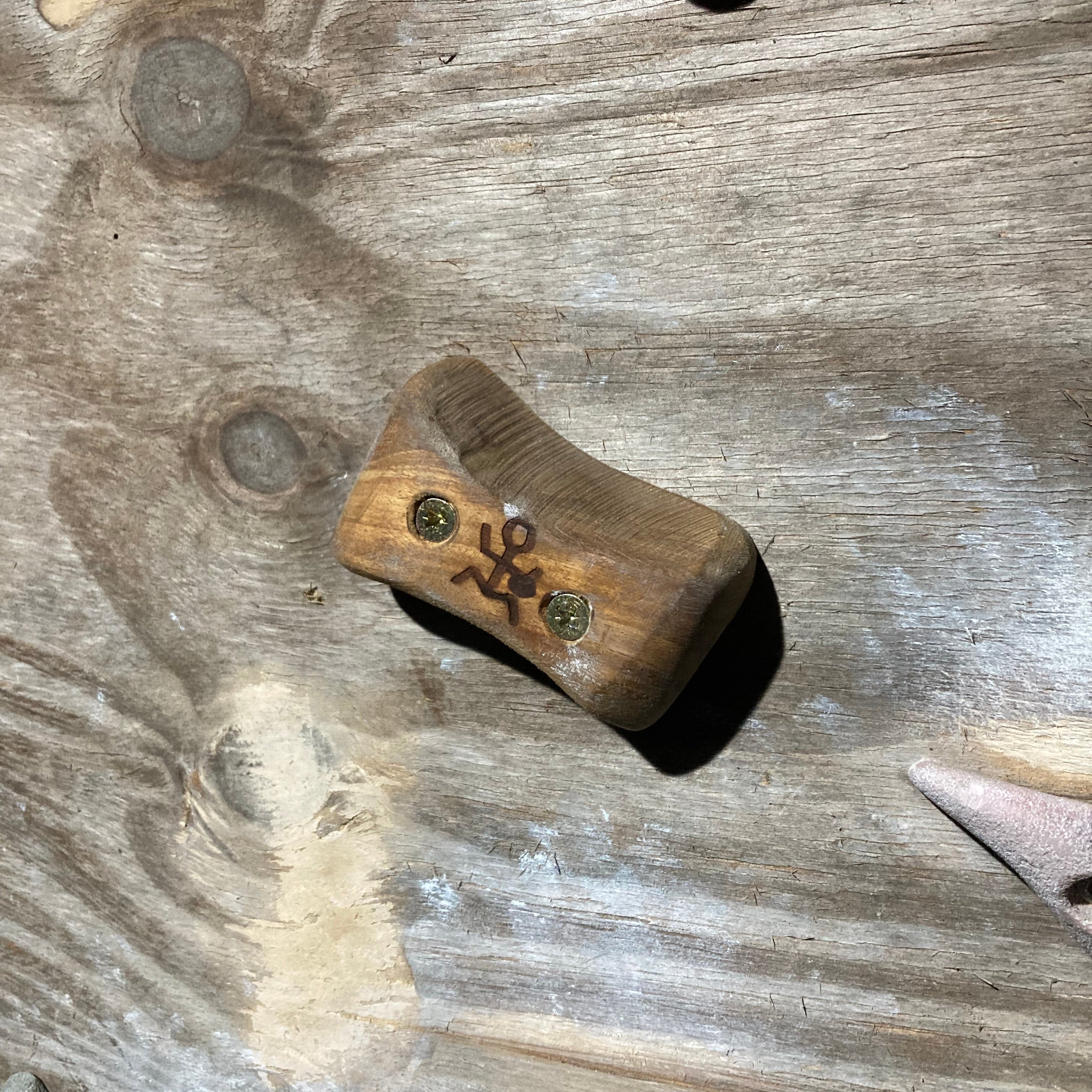 pinch climbing hold screwed onto board