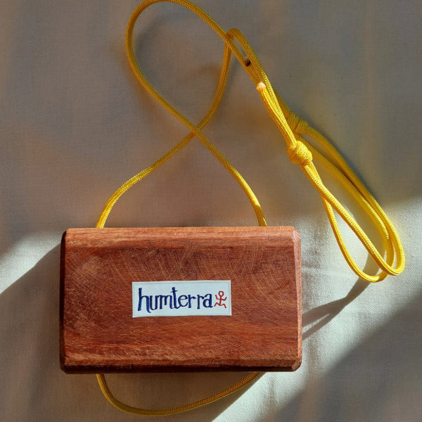 backside of wooden portable hangboard with yellow paracord