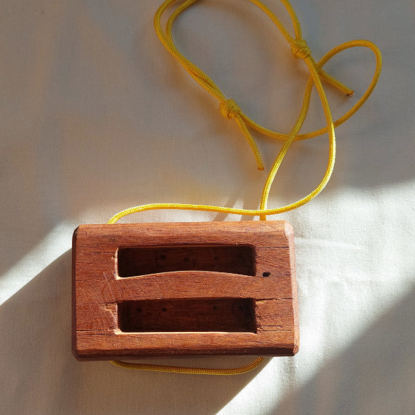 front of wooden portable hangboard with yellow paracord