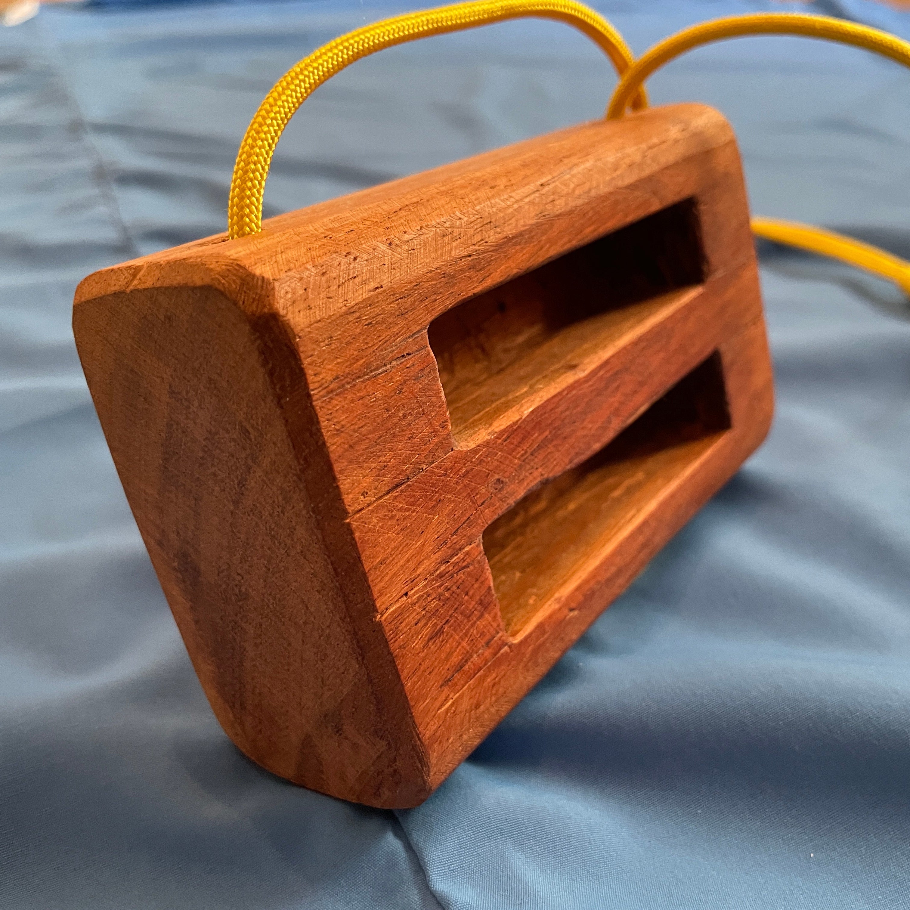 sideview of wooden portable hangboard for climbing