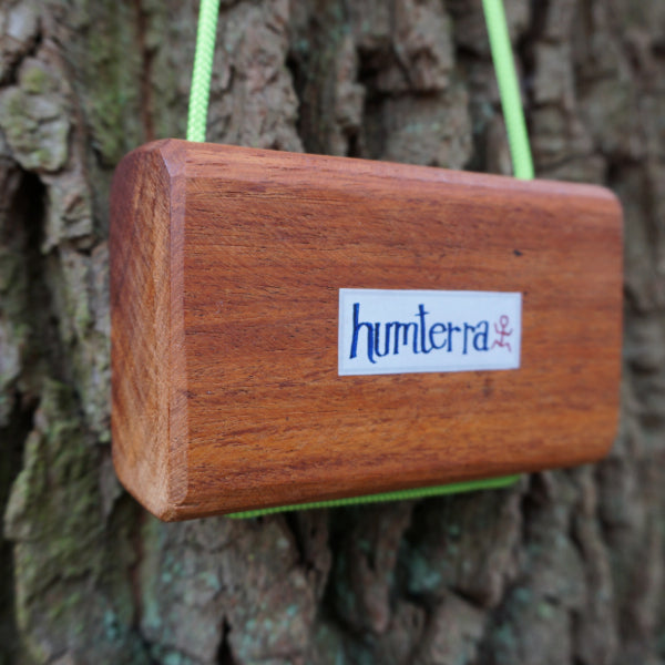 back view of wood hangboard with tree in background 