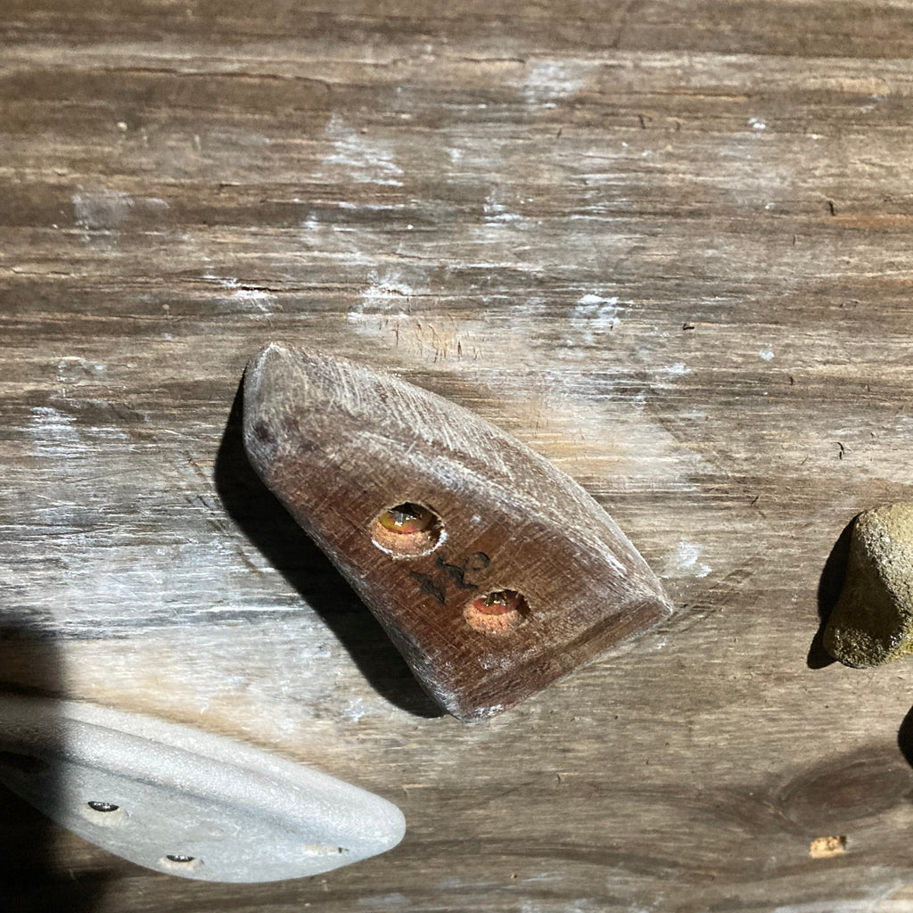 closeup of wooden crimpy climbing hold